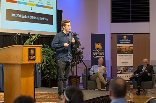 Man explaining business plan on stage during challenge