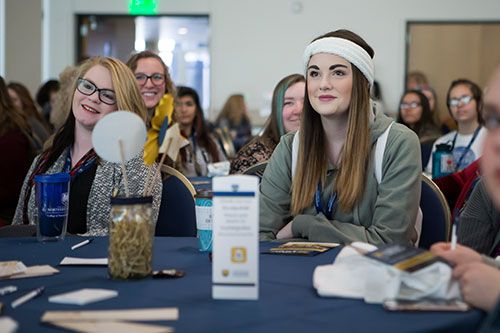 Woman sitting at table at conference